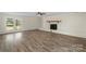 Spacious living room with brick fireplace and glass patio doors leading to the backyard at 2509 Wesley Chapel Rd, Indian Trail, NC 28079