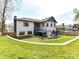 Landscaped backyard with patio and outdoor fireplace at 3416 Windsor Dr, Charlotte, NC 28209