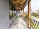 Inviting balcony with custom wood ceiling, black railings, and stylish outdoor furniture, perfect for enjoying the neighborhood views at 3416 Windsor Dr, Charlotte, NC 28209