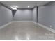Unfinished basement with painted floor, offering potential for customization and extra space at 3416 Windsor Dr, Charlotte, NC 28209