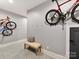 Functional basement featuring gray epoxy flooring, bike racks, bench, and coat hooks at 3416 Windsor Dr, Charlotte, NC 28209