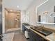 Modern bathroom with dual vanities, sleek black fixtures, and a spacious walk-in shower with unique tile work at 3416 Windsor Dr, Charlotte, NC 28209