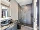 Sleek bathroom design with a black vanity, glass shower, tiled walls and floors at 3416 Windsor Dr, Charlotte, NC 28209