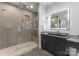 Modern bathroom featuring a luxurious walk-in shower with glass door and a sleek vanity with LED mirror at 3416 Windsor Dr, Charlotte, NC 28209