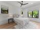Bright bedroom featuring a cozy bed, soft rug, and ample natural light from the windows at 3416 Windsor Dr, Charlotte, NC 28209