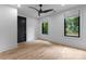 Minimalist bedroom featuring hardwood floors, clean lines, neutral colors, and large windows for natural light and ventilation at 3416 Windsor Dr, Charlotte, NC 28209