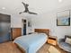Bright bedroom with a mid-century modern design, sleek ceiling fan, two large windows, and hardwood flooring at 3416 Windsor Dr, Charlotte, NC 28209