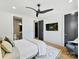 Spacious bedroom with a modern ceiling fan, en-suite bathroom, walk-in closet, and stylish decor for a relaxing retreat at 3416 Windsor Dr, Charlotte, NC 28209