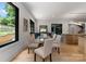 Stylish dining area with a glass table and views of the kitchen and outdoor scenery at 3416 Windsor Dr, Charlotte, NC 28209