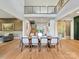 Dining room boasting a large dining table, a double-height ceiling, and hardwood floors at 3416 Windsor Dr, Charlotte, NC 28209
