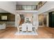 Open-concept dining room with hardwood floors, modern light fixture, and access to the staircase at 3416 Windsor Dr, Charlotte, NC 28209