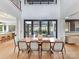 Dining room with tall ceilings, a large table and access to an outdoor patio through glass doors at 3416 Windsor Dr, Charlotte, NC 28209