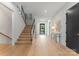 Bright foyer features hardwood floors and a modern staircase, creating an inviting entrance at 3416 Windsor Dr, Charlotte, NC 28209