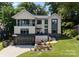 Attractive modern home with manicured lawn and a black garage door, creating a welcoming curb appeal at 3416 Windsor Dr, Charlotte, NC 28209