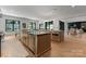 Bright, open kitchen with wood floors, island, and stainless steel appliances at 3416 Windsor Dr, Charlotte, NC 28209