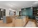 Bright, open kitchen with wood floors, island, stainless appliances, and modern lighting at 3416 Windsor Dr, Charlotte, NC 28209