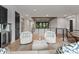 Bright living area with chic seating, a modern rug, wet bar, and access to the upper level with scenic views at 3416 Windsor Dr, Charlotte, NC 28209