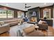 Cozy living room with a modern fireplace, a ceiling fan, and lots of seating at 3416 Windsor Dr, Charlotte, NC 28209