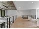 Open loft area with wooden floors, modern railings, stylish seating, and ample natural light for a cozy ambiance at 3416 Windsor Dr, Charlotte, NC 28209