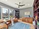 Spacious office with built-in bookshelves, a large wood desk, and cozy seating area at 3416 Windsor Dr, Charlotte, NC 28209