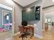 Office space with custom cabinets, wood desk, chair, and bright view to the exterior at 3416 Windsor Dr, Charlotte, NC 28209