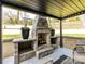Outdoor fireplace with stone surround, and covered patio at 3416 Windsor Dr, Charlotte, NC 28209