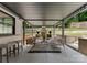 Inviting outdoor patio with comfortable seating, stone fireplace, and pergola for shaded relaxation at 3416 Windsor Dr, Charlotte, NC 28209
