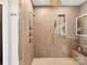 Luxurious walk-in shower featuring stylish vertical tiling, dual shower heads, a built-in niche, and a convenient bench at 3416 Windsor Dr, Charlotte, NC 28209