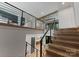 Elegant staircase with wooden steps and sleek metal railings, leading to an upper level with a modern design at 3416 Windsor Dr, Charlotte, NC 28209