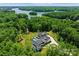 Aerial view of an estate featuring a grand home, pool, sprawling lawns, and lake access at 406 Morrison Farm Rd, Troutman, NC 28166