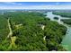 Aerial view of a home nestled amongst lush greenery with lake access at 406 Morrison Farm Rd, Troutman, NC 28166