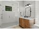 Modern bathroom featuring a glass-enclosed shower with rain head and wood vanity at 406 Morrison Farm Rd, Troutman, NC 28166