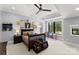 A bright bedroom with a ceiling fan, window view, and decorative wall art at 406 Morrison Farm Rd, Troutman, NC 28166