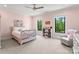 A cozy bedroom with pink walls, decorative bedding, and plenty of natural light at 406 Morrison Farm Rd, Troutman, NC 28166