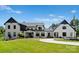 Beautiful modern farmhouse with manicured lawn, circular driveway and lush landscaping at 406 Morrison Farm Rd, Troutman, NC 28166