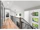 Hallway features wood floors and a modern railing overlooking the lower level at 406 Morrison Farm Rd, Troutman, NC 28166