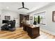 This home office features a hardwood floor, built-in bookshelf, and large desk with view to the outside at 406 Morrison Farm Rd, Troutman, NC 28166