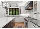 Gourmet kitchen featuring custom white cabinetry, an island, and stainless steel appliances at 406 Morrison Farm Rd, Troutman, NC 28166