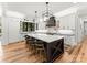 Stylish kitchen with a large center island, white cabinets, and modern lighting fixtures at 406 Morrison Farm Rd, Troutman, NC 28166