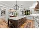 Spacious kitchen with an island and plenty of counter space, flowing into the living room at 406 Morrison Farm Rd, Troutman, NC 28166