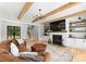 Spacious living room featuring hardwood floors, brick fireplace, and wooden beams at 406 Morrison Farm Rd, Troutman, NC 28166