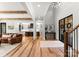 Open-concept living room featuring wood beams, hardwood floors, and seamless flow to a modern kitchen at 406 Morrison Farm Rd, Troutman, NC 28166