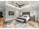 A spacious main bedroom showcases a decorative ceiling, fan, and elegant furnishings at 406 Morrison Farm Rd, Troutman, NC 28166