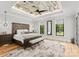 Elegant main bedroom featuring a decorative ceiling, large windows, and hardwood floors at 406 Morrison Farm Rd, Troutman, NC 28166