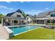 A stunning outdoor pool and lounge area with a covered patio, bar, and spa at 406 Morrison Farm Rd, Troutman, NC 28166