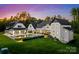 Expansive backyard featuring a pool, lounge chairs, covered porch, and lush landscaping at 406 Morrison Farm Rd, Troutman, NC 28166