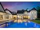 Back of a luxury home featuring a beautiful pool, lounge chairs, and elegant outdoor living spaces at 406 Morrison Farm Rd, Troutman, NC 28166