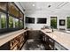 Modern wet bar with dark cabinetry, ample counter space, and built-in shelves for liquor and glassware at 406 Morrison Farm Rd, Troutman, NC 28166