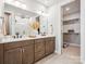 Elegant bathroom features double sinks, modern lighting, and walk-in shower at 408 Old Town Village Rd, Waxhaw, NC 28173