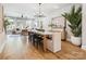 Open-concept dining area with modern chandelier and seamless flow to the living room at 408 Old Town Village Rd, Waxhaw, NC 28173